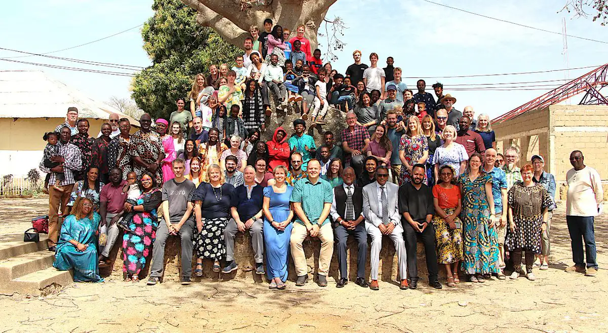 A group wearing Hope Beyond Borders vests with staff in front of a Sickle Cell Centre banner in Jos, Plateau State, June 2025.